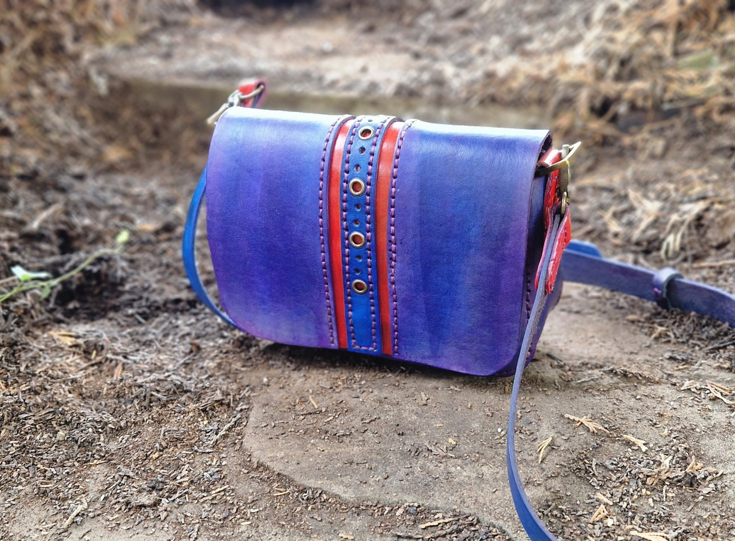 Perforated red an blue handbag