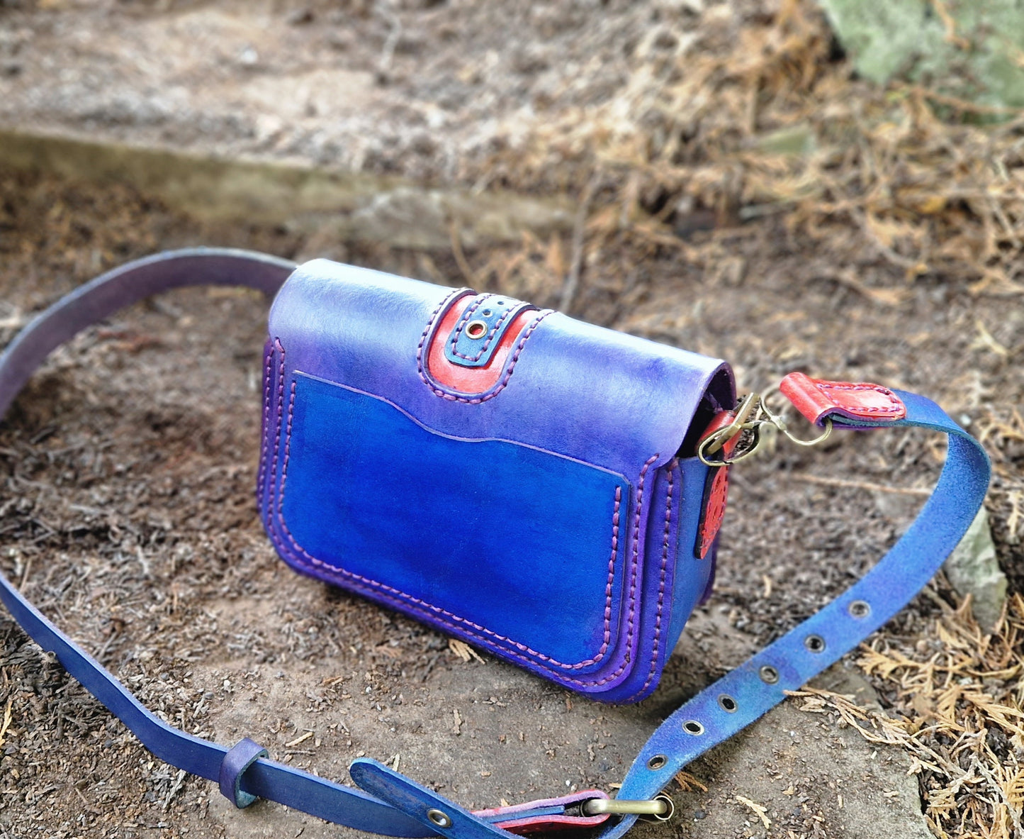 Perforated red an blue handbag